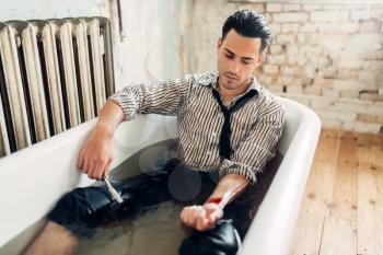 Businessman bankrupt slit his wrists in bathtub, suicide man concept. Problem in business, stress