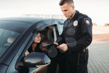 Male cop in uniform checks license of female driver. Law protection, car traffic inspector, safety control job
