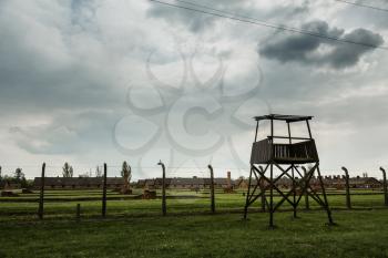 Watchtower and barbed wire fence, German concentration camp Auschwitz II, Poland. Museum of victims of the nazi genocide of the Jewish people