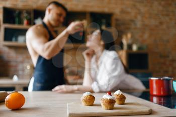 Attractive love couple in underwear cooking on the kitchen together. Naked man and woman preparing breakfast at home, food preparation without clothes