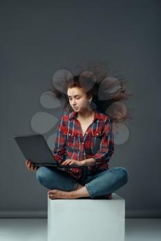 Strong wind blowing on woman with laptop, funny emotion. Powerful air flow blows on female person, black background