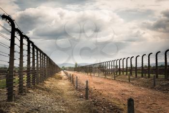 Barbed wire fence in two rows, German concentration camp Auschwitz II, Poland. Museum of victims of the nazi genocide of the Jewish people