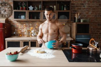 Man in underwear cooking dessert on the kitchen. Naked male person preparing breakfast at home, food preparation without clothes
