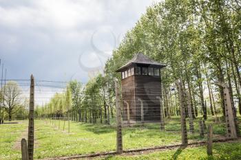 Watchtower and barbed wire fence on territory of German concentration camp Auschwitz II, Poland. Museum of victims of the nazi genocide of the Jewish people