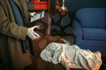 Male detective in gloves holds notebook, victim under the cape at the crime scene, retro style. Criminal investigation, inspector is working on a murder, vintage room interior on background