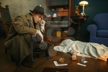 Male detective in gloves thinks, victim under the cape at the crime scene, retro style. Criminal investigation, inspector is working on a murder, vintage room interior on background