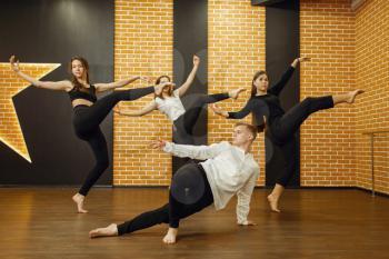Contemporary dance performers posing in studio. Female and male dancers training in class, modern grace dancing, stretching exercise, acrobats