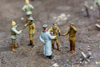 The officer and soldiers at a halt, miniature scene outdoor, europe. Mini figures with high detaling of objects, realistically diorama, toy model