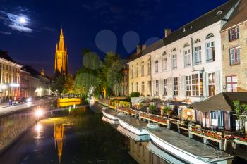 Belgium, Brugge, ancient European town, night cityscape with view on church and river. Tourism and travel, famous europe landmark, popular places, West Flanders, benelux