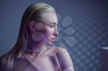 Portrait of futuristic young woman in white clothes, grey background. Female person in virtual reality style, future technology, futurism