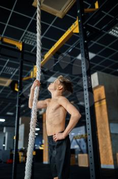 Athletic boy doing rope exercise in gym. Youngster on training in sport club, healthcare and healthy lifestyle, schoolboy on aerobics workout, sportive youth