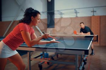 Table tennis, male and female ping pong players. Couple playing table-tennis indoors, sport game with racket and ball, active healthy lifestyle