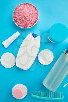 Oral and skin care products, blue background, nobody. Morning healthcare procedures concept, toothcare, toothbrush and toothpaste