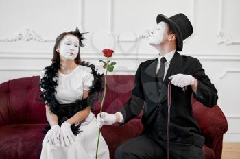 Two mime artists, love couple, scene with rose. Pantomime theater, parody comedian, positive emotion, humour performance, funny face mimic and grimace
