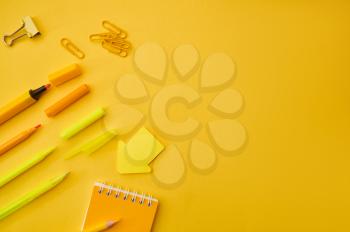 Office stationery supplies, all in yellow tones. School or education accessories, writing and drawing tools