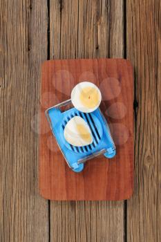 Halved boiled egg and an egg cutter