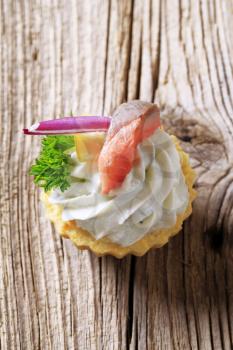 Tart pastry with spread and fish topping 