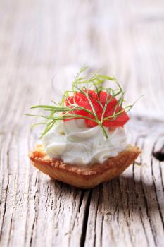 Pastry-based canape with savory spread and caviar