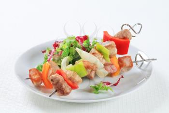 Chicken and pork skewers with green salad