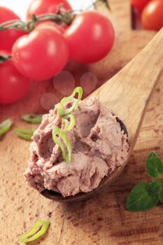 Liver pate on a wooden spoon - closeup