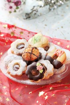 Variety of Christmas cookies on a festive tablecloth