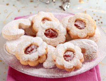 Jam cookies and vanilla crescents powdered with icing sugar