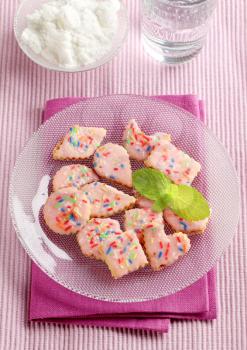 Pink frosted sugar cookies with colorful sprinkles