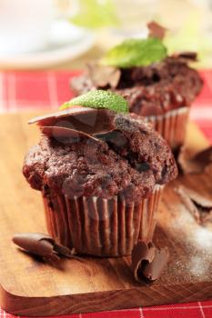 Delicious double chocolate muffins on cutting board 