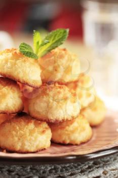 Stack of coconut macaroons on a decorative plate