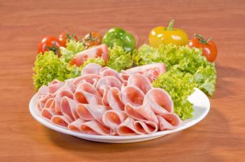 Slices of Mortadella salami and fresh vegetable