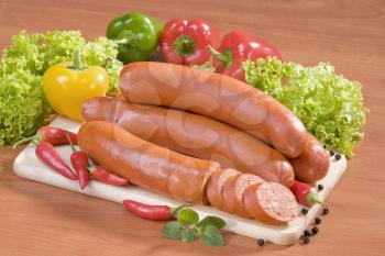 Still life of sausages and fresh vegetables
