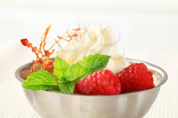 Creme brulee with raspberries and whipped cream