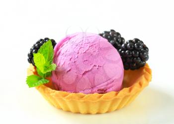Scoop of fruit ice cream with fresh blackberries in a tart shell