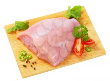 Raw skinless turkey breast  on cutting board