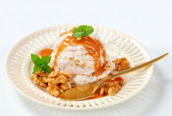 Scoop of walnut ice cream with caramel sauce