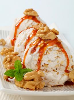 Scoops of walnut ice cream with caramel sauce