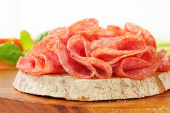 Slice of bread with dry salami