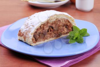 Slice of apple strudel powdered with icing sugar