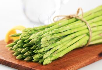 Bundle of Fresh asparagus shoots on a cutting board