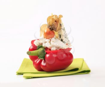 Cheese stuffed red bell pepper garnished with physalis fruit