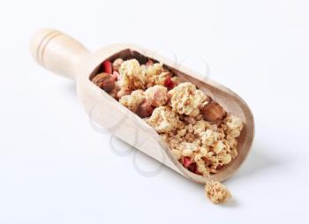 Scoop of strawberry granola cereal with hazelnuts