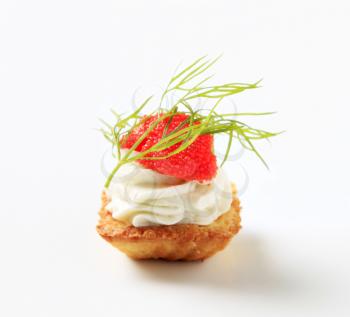 Pastry topped with savory spread and caviar