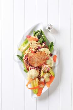Marinated pork chop on bed of vegetable salad