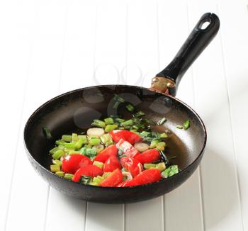 Sauteeing vegetables in a fry pan