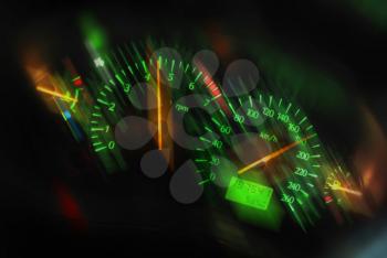 Closeup of a tachometer and speedometer on a sports car dashboard