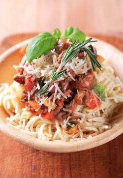 Spaghetti and meat-based sauce sprinkled with cheese