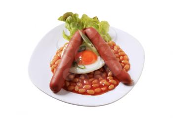 English breakfast of baked beans, sausages, fried egg