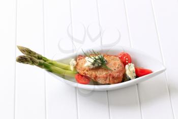 Marinated pork chop with blue cheese and vegetables