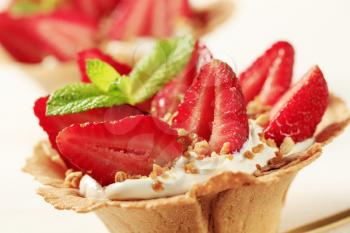 Pastry cup filled with cream and fresh strawberries