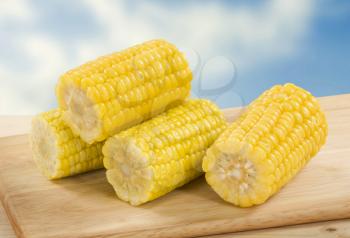 Sweet corn cobs on a cutting board